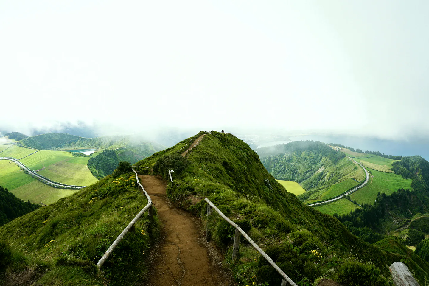 A narrow ridge path leading between two calderas